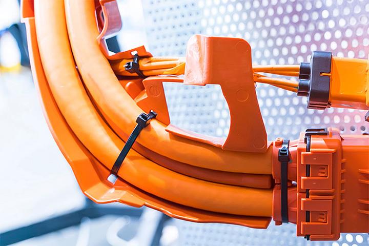 An image of orange colored high voltage cables.